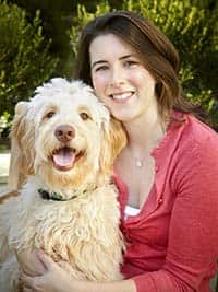 Ashley Gallagher, DVM hugging her dog.